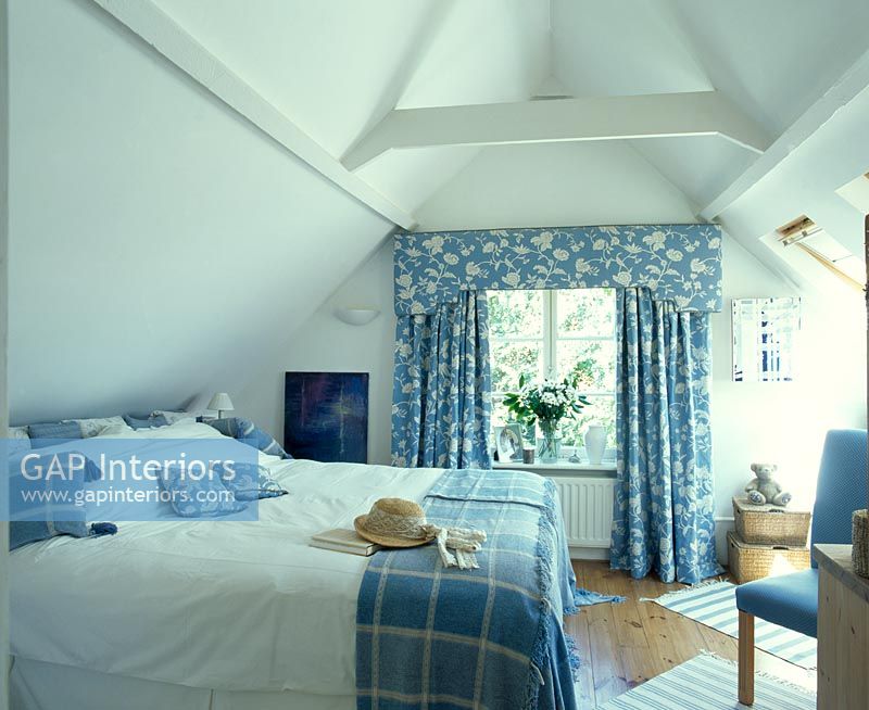 Bedroom with blue and white floral curtains