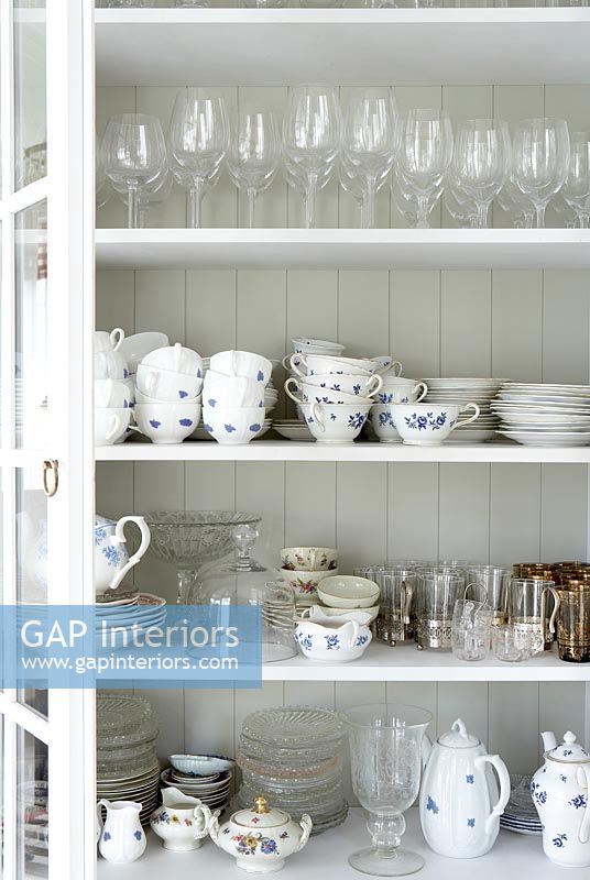 Crockery and glassware in cabinet 