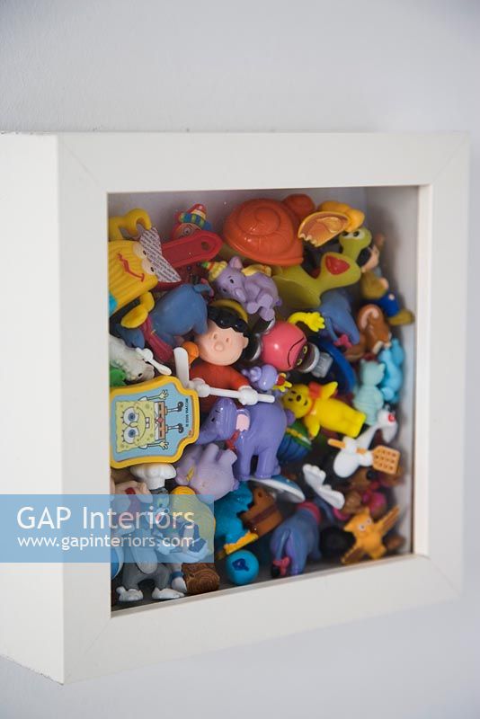 Toys in a wall mounted box frame, detail 