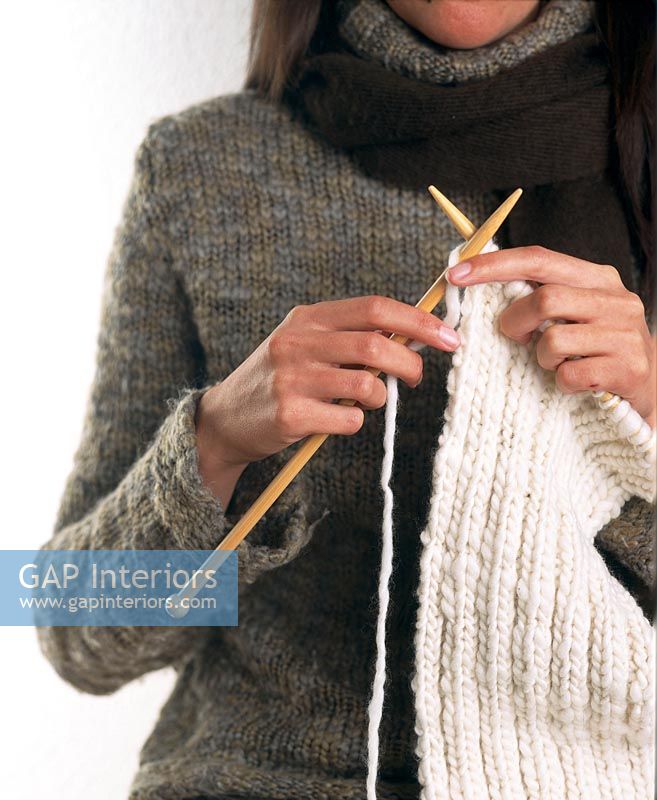 Woman in a sweater knitting