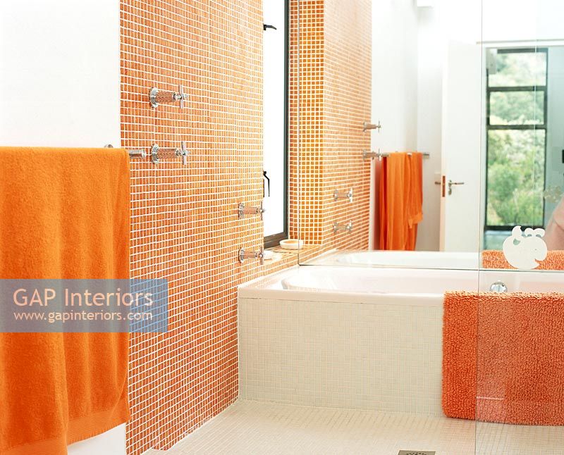 Interior of modern bathroom with bathtub and towel rail