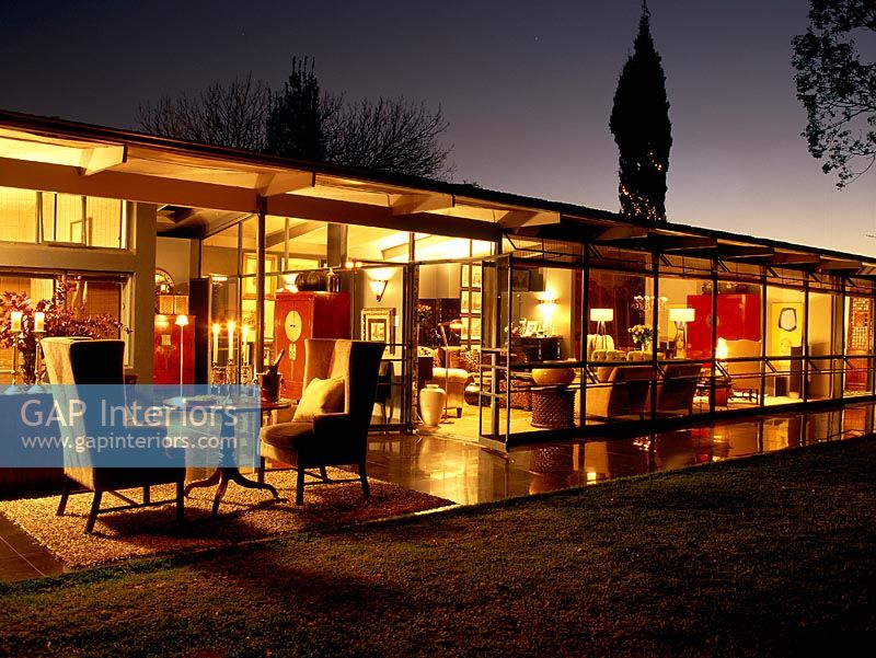 Illuminated modern home seen from outside at night