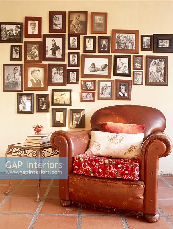 Leather Armchair in front of photo collection on wall