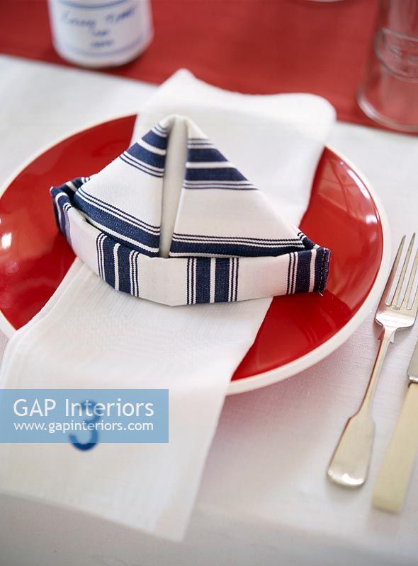 View of napkin on plate with fork and knife