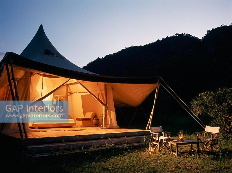 Safari tent bedroom at dusk