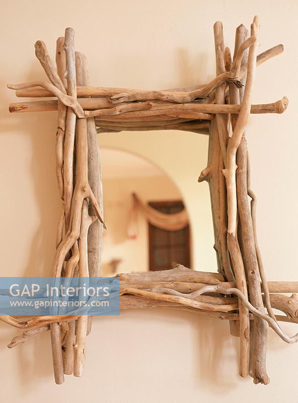 Mirror with a frame made from twigs