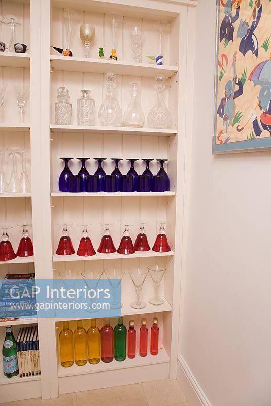 Colourful glassware on shelves
