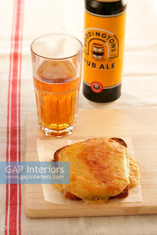 Close-up of a bottle and glass of ale and a baked toast