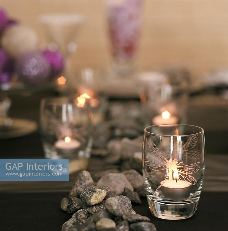 Illuminated candles in glass, close-up