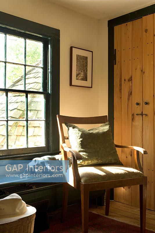 Armchair by wooden door 