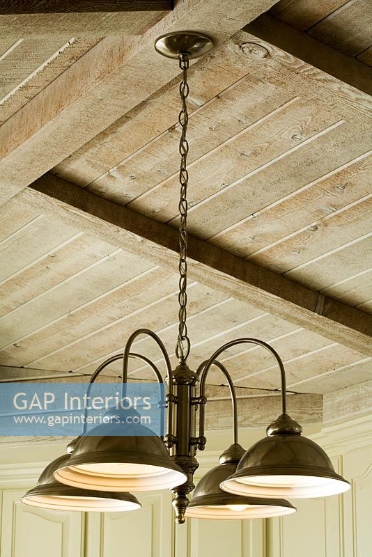 Light Fixture Hanging from Wood Beam Ceiling