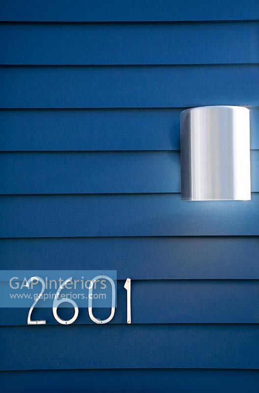 Modern House Numbers and Light on Blue Wall