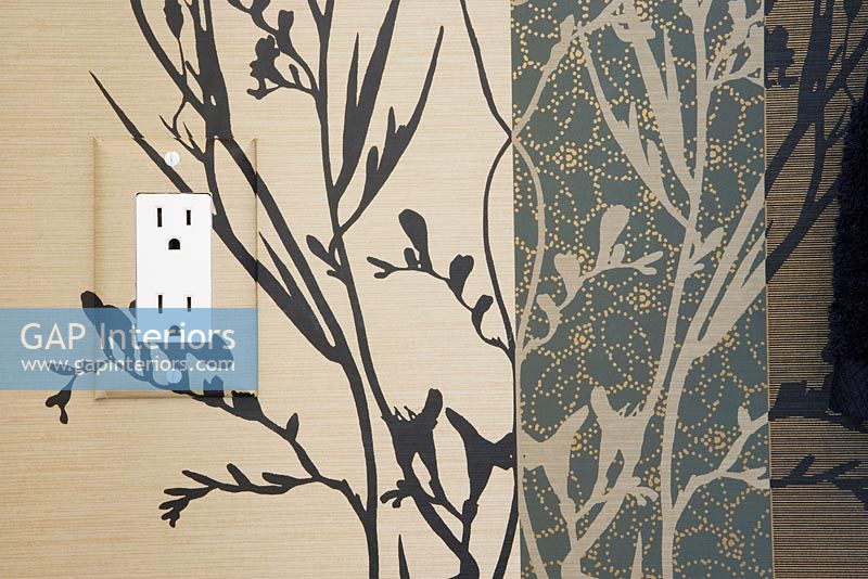 Detail of electrical socket on a wallpapered wall