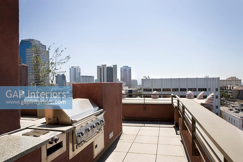 BBQ area on patio with city view in background