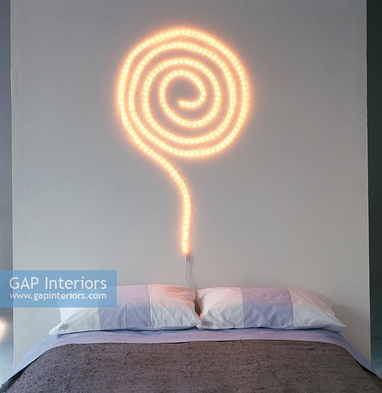 Bedroom with a lighted spiral wall decoration