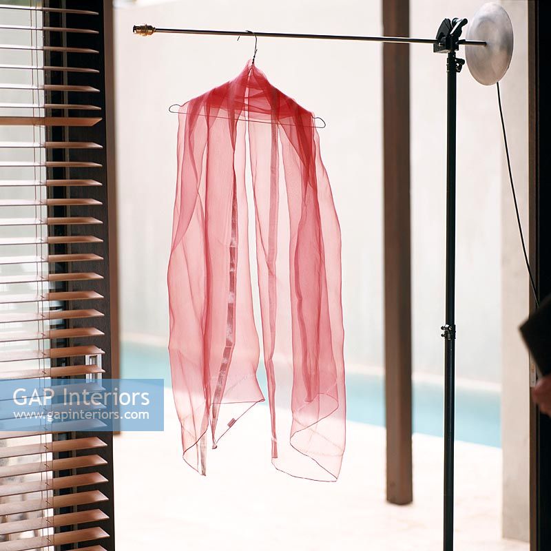 Light fabric shawl hanging on a coat hanger