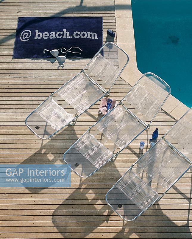 Overhead view of lounge chairs next to a pool