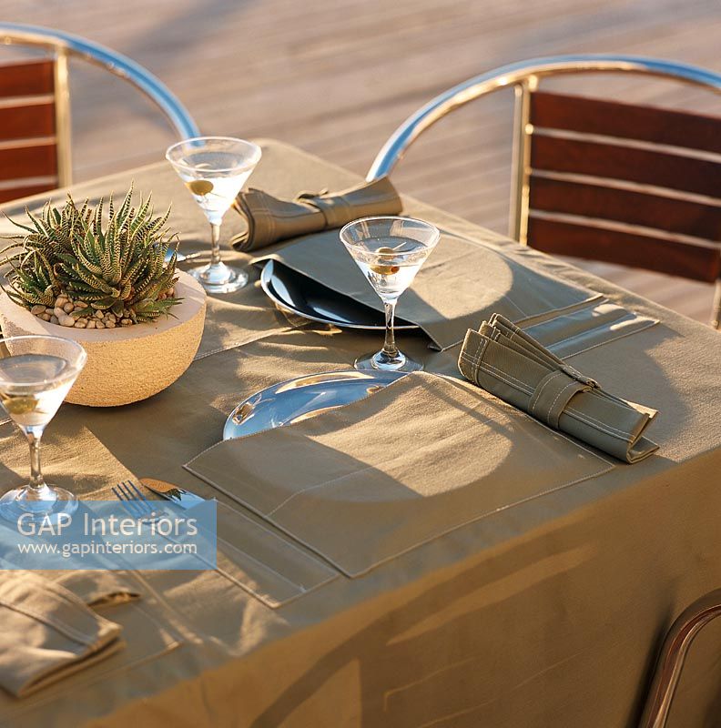 Place setting on dining table with martini glasses