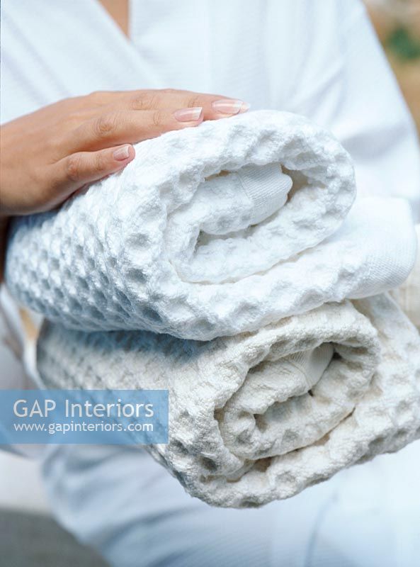 Woman holding rolled up towels