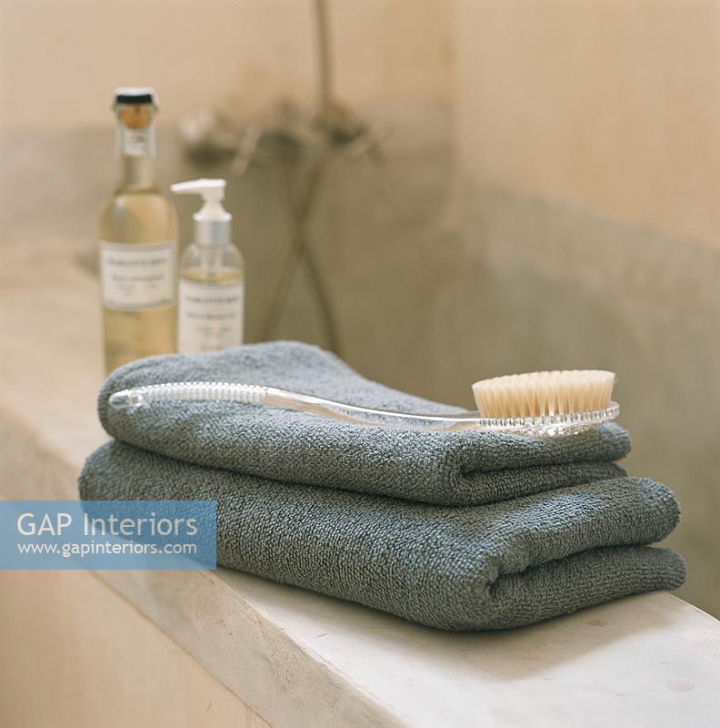 Two towels with a scrub brush