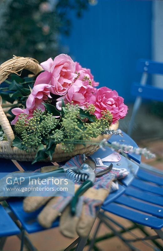 Flowers in basket with gloves