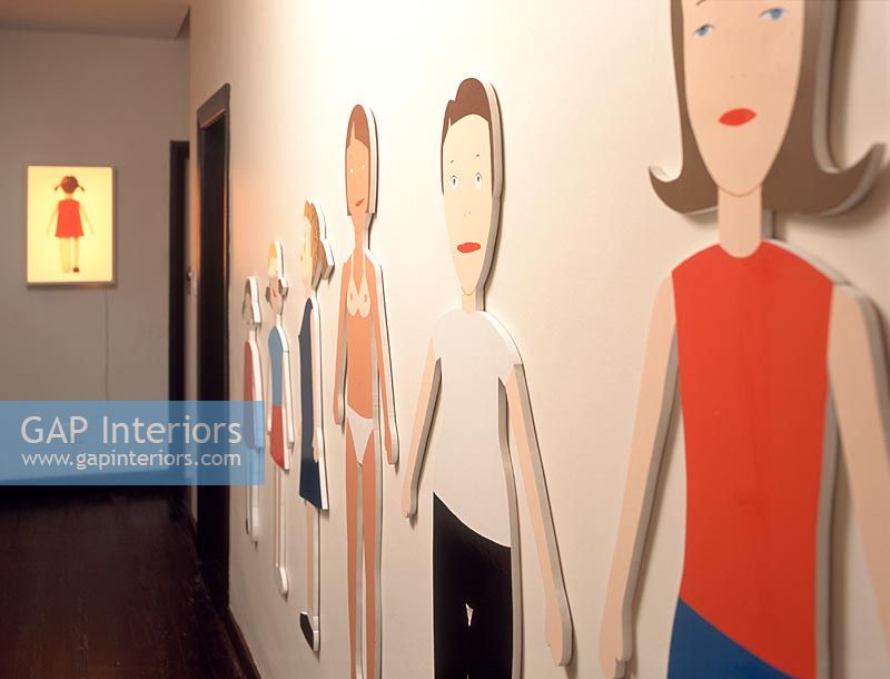 Cut-outs of people decorating a wall