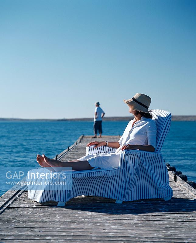 Woman relaxing in a chair on a dock