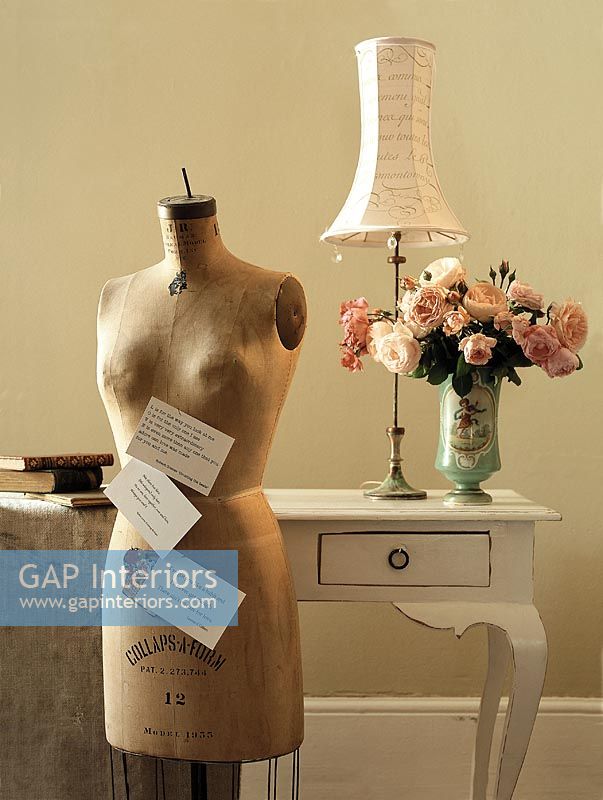 Mannequin and flower vase on side table