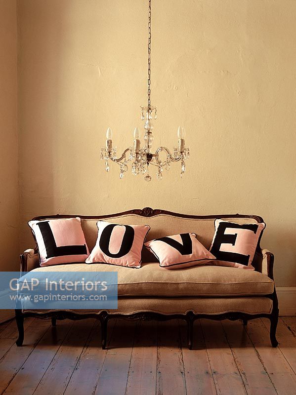 Vintage sofa with pillows that spell out love