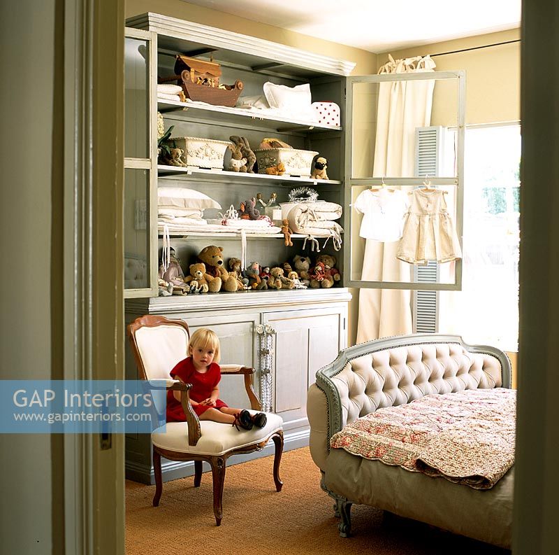 Girl sitting on chair in bedroom