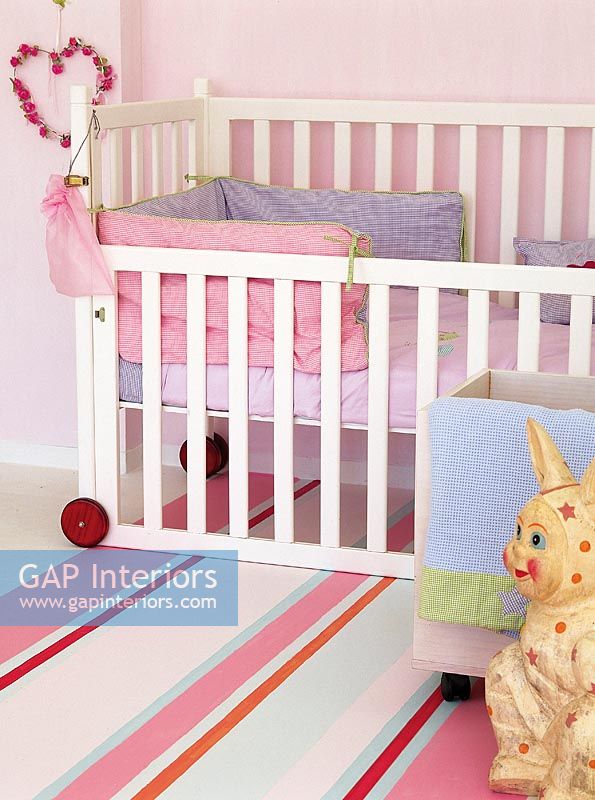 Toddlers bedroom with crib and toys