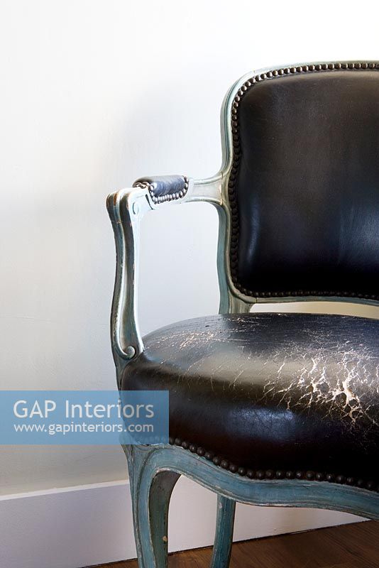 Black Antique leather chair with worn seat