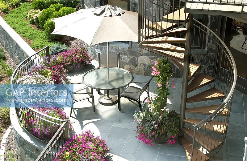 Contemporary patio with spiral staircase