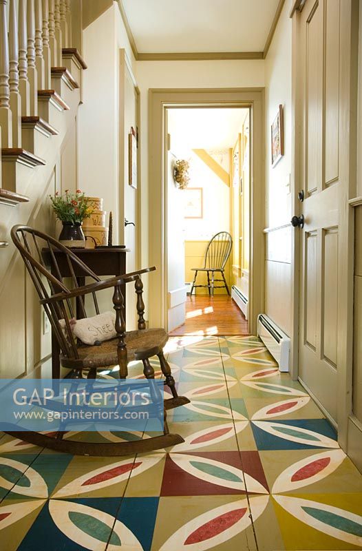 Hallway in colonial home with colourful wooden floor