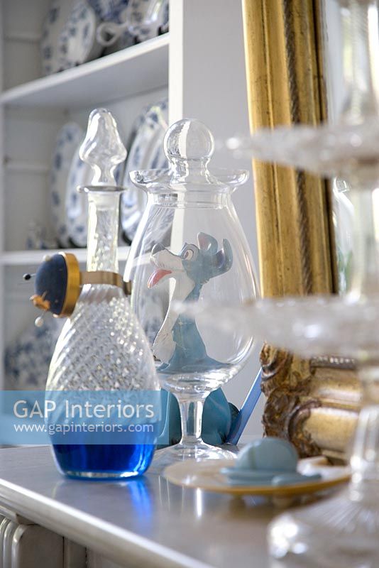 Glassware and collectibles on mantelpiece 