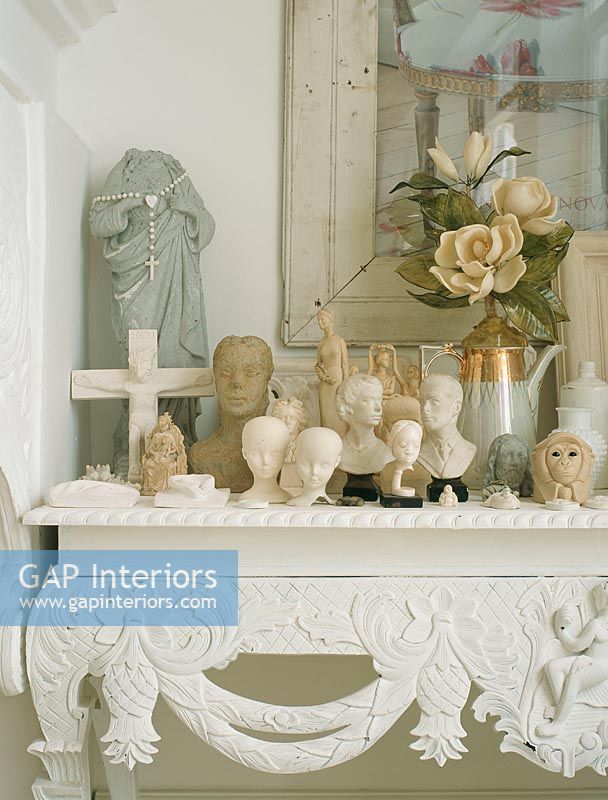 Console table with collection of vintage busts