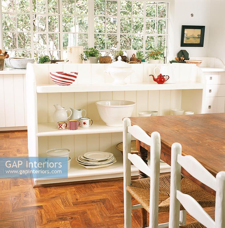 Crockery on shelf with dining table