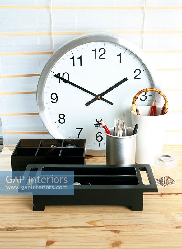 Detail desk supplies and a wall clock
