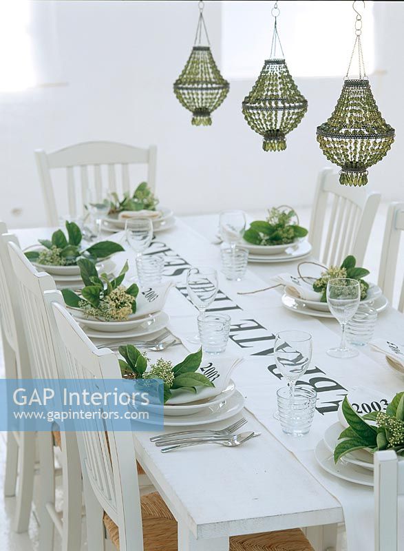 Place setting on dining table with wine glasses