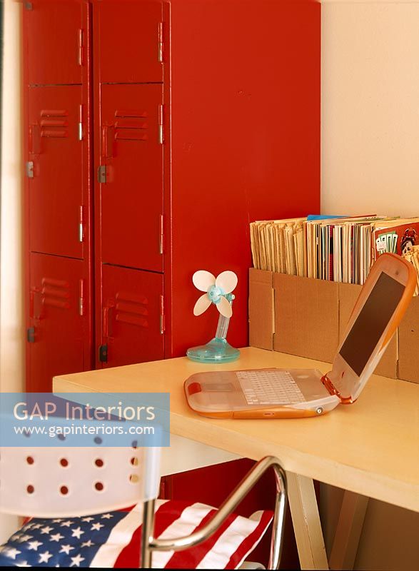 Childrens room with laptop on desk and school locker storage