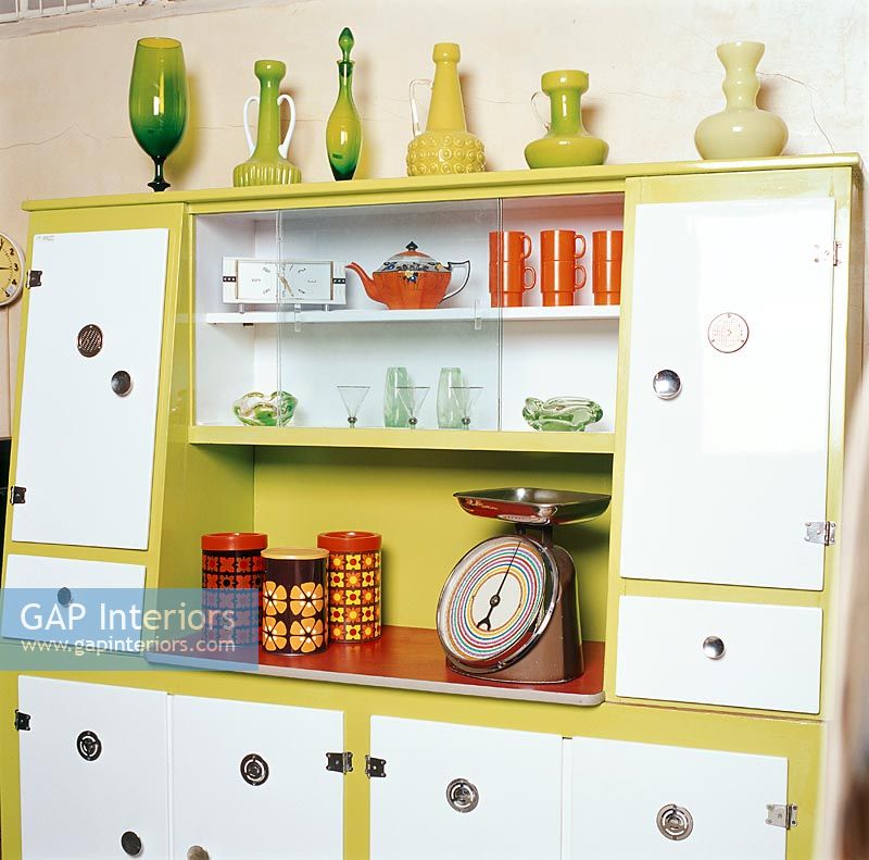 Kitchen scales and flower vases on cupboard