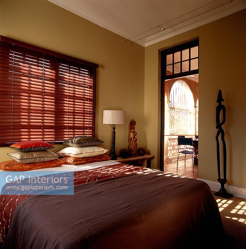 A brown bedroom with a double bed