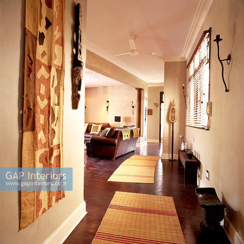 An African corridor with wooden flooring and rugs