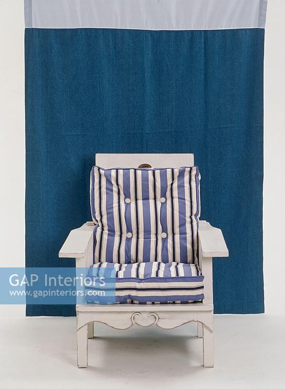 Blue and white striped chair against a blue background