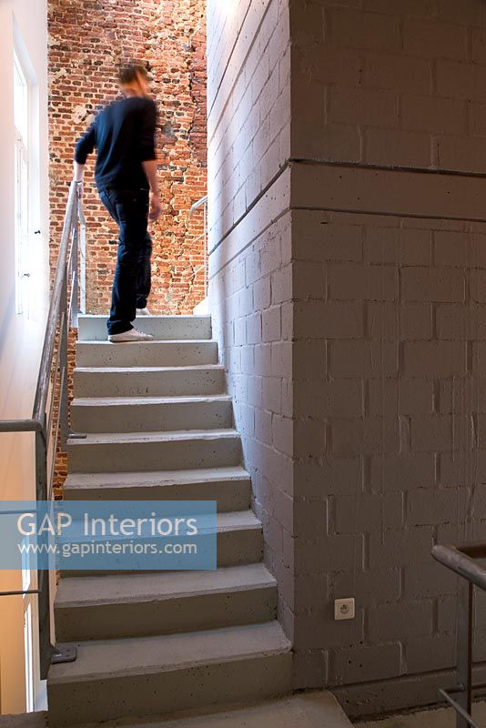 Man walking up modern staircase 