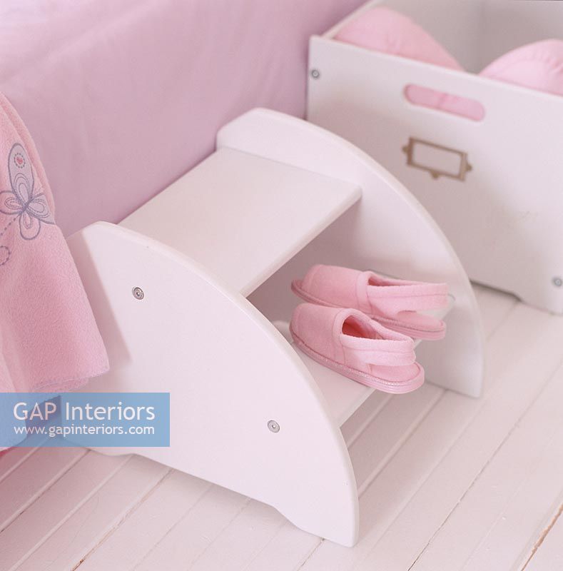 Pink footwear on shelf in a pink room