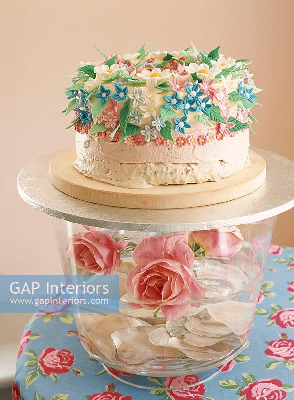 View of flowers in bowl with cake close-up