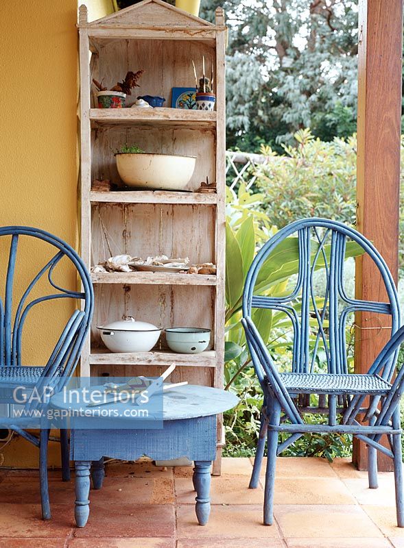 Two painted chairs and wooden shelves