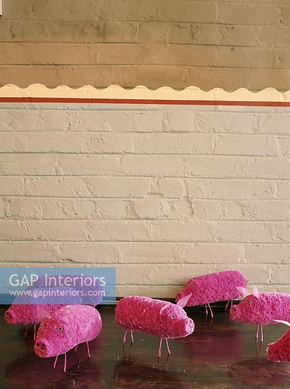 A brick wall and pink toys