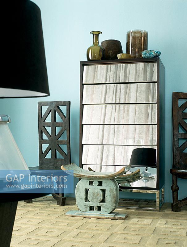 Ethnic stool and mirrored cupboard